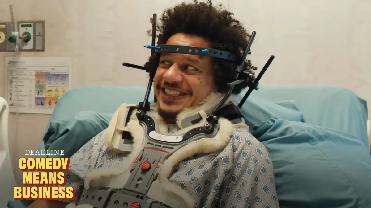 Eric Andre laughing intensely on a stage.