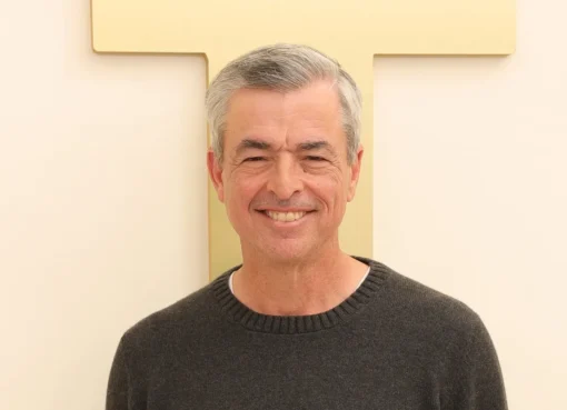 Eddy Cue, Senior Vice President at Apple, smiling and speaking on stage.