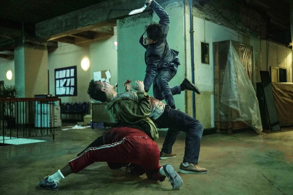Martial artists engaged in a dynamic, high-flying fight sequence from 'The Furious' movie.