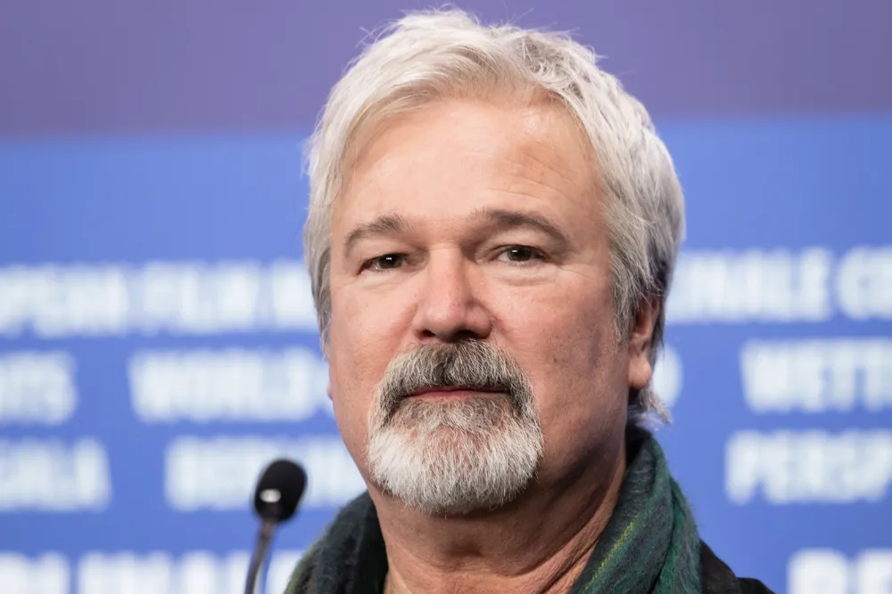 Gore Verbinski speaking at a film festival, looking serious but engaged.