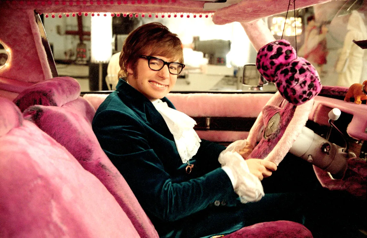Mike Myers smiling while talking to fans at an event
