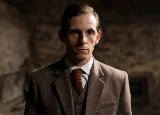 Jamie Bell looking thoughtful and smiling slightly.
