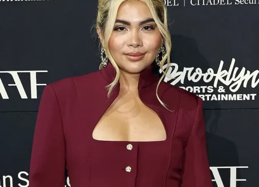 Hayley Kiyoko smiling, looking thoughtful and confident.
