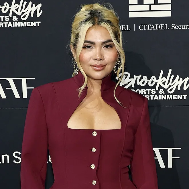 Hayley Kiyoko smiling, looking thoughtful and confident.