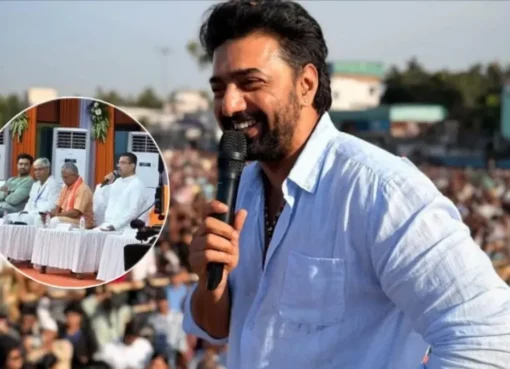 Actor and MP Dev smiling.