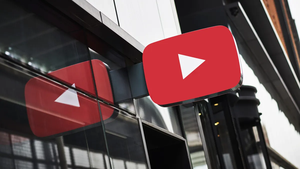 A smartphone screen displaying the YouTube logo, with blurred images of news headlines and baseball game clips in the background.
