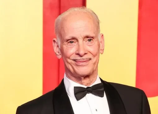 A photo of John Waters, looking thoughtful.