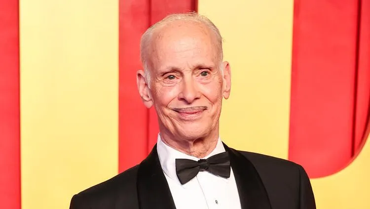 A photo of John Waters, looking thoughtful.