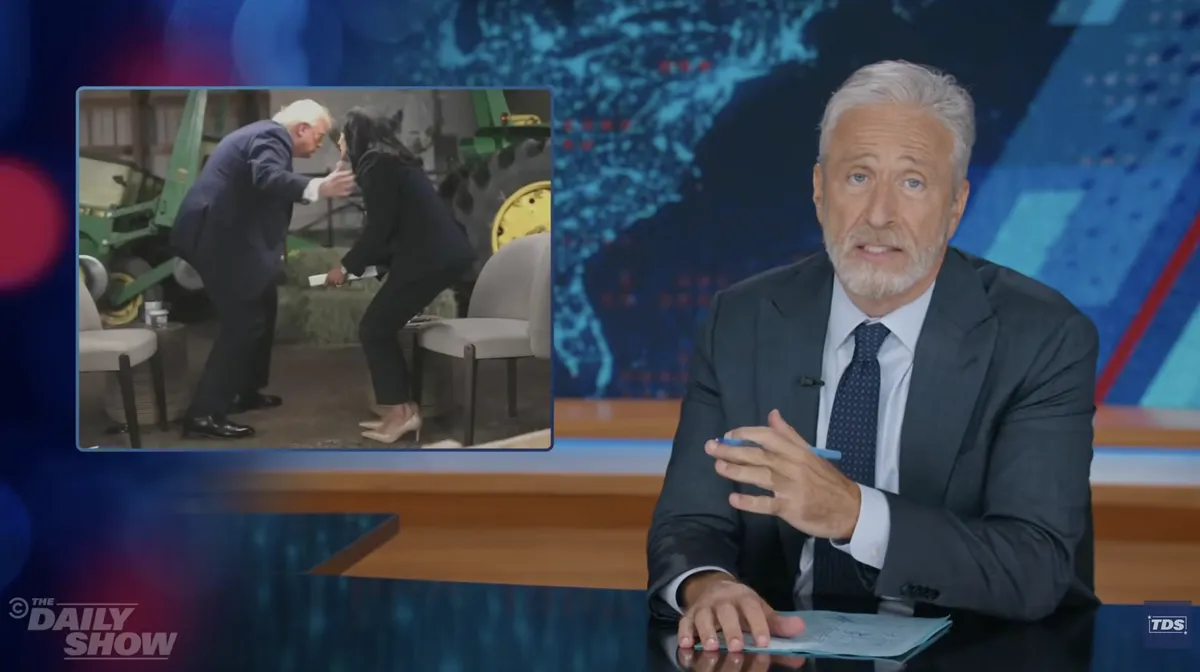 Jon Stewart laughing on the set of the Daily Show