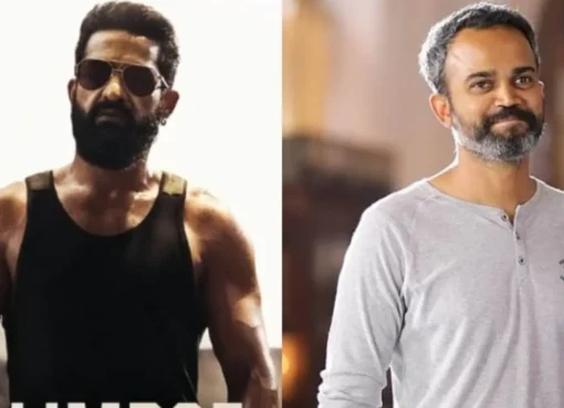 Jr NTR in a powerful, intense pose from the movie 'Dragon' against a dark, dramatic background.