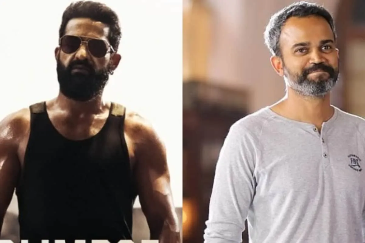 Jr NTR in a powerful, intense pose from the movie 'Dragon' against a dark, dramatic background.