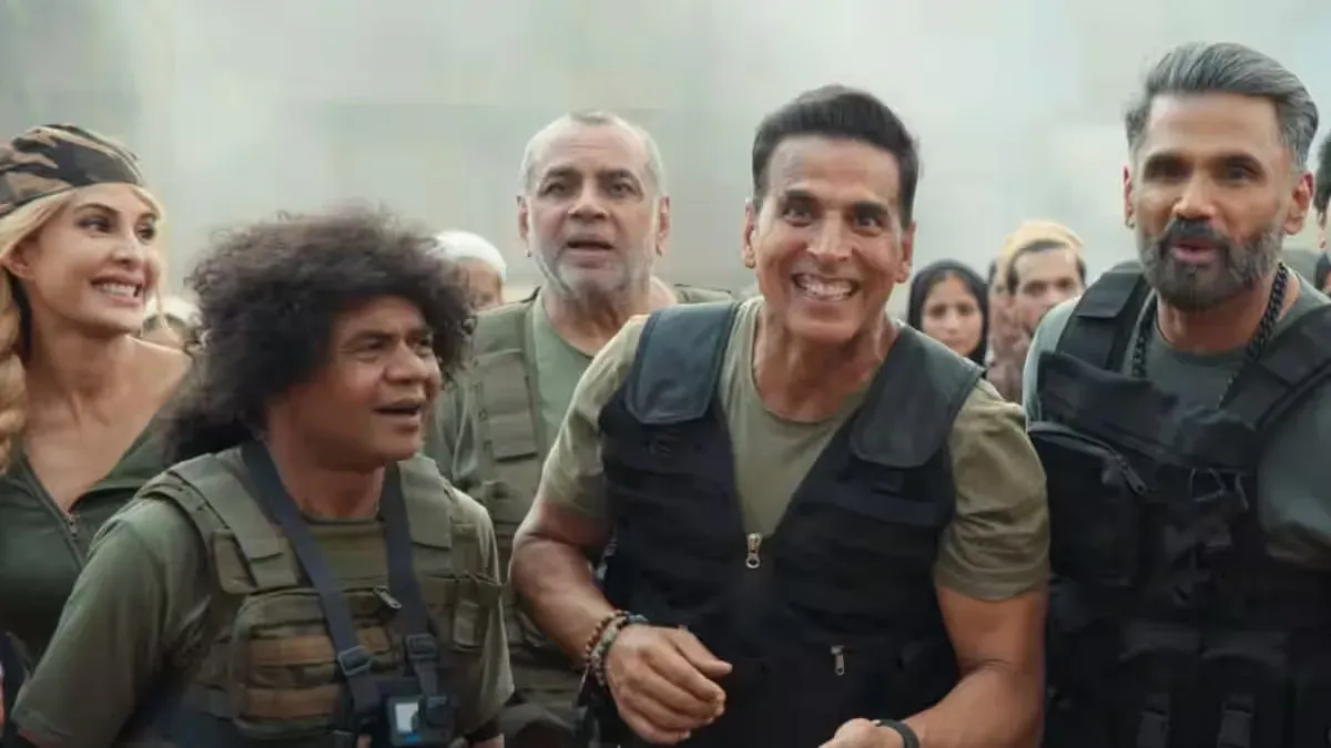 Akshay Kumar smiling in a promotional poster for "Welcome To The Jungle" with jungle-themed elements.