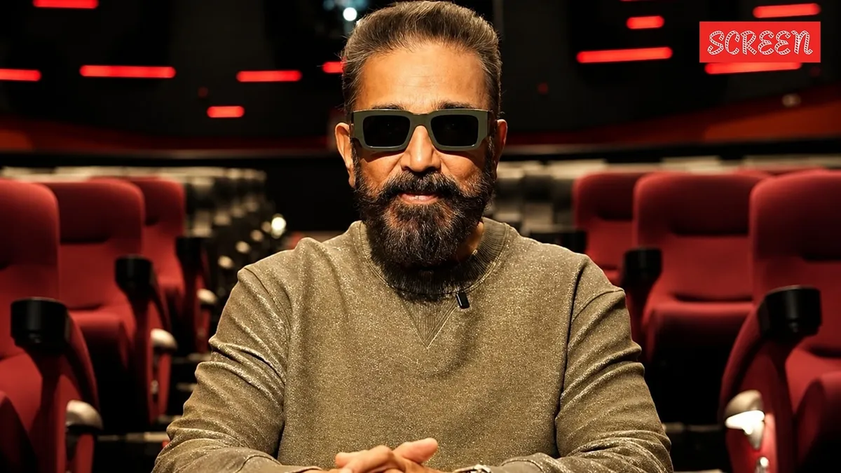 Kamal Haasan looking thoughtful, perhaps against a backdrop hinting at a grand film production.