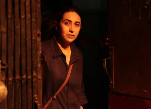 Karisma Kapoor looking intense in a dark scene from the thriller Brown