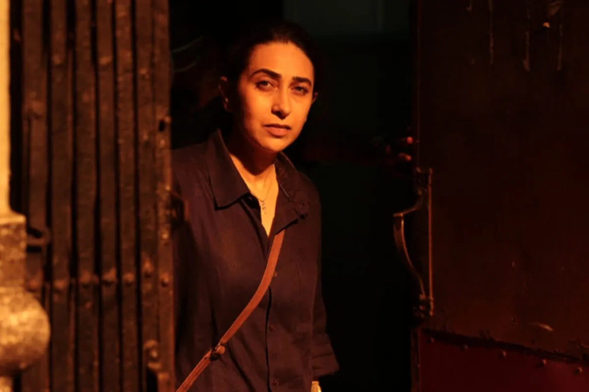 Karisma Kapoor looking intense in a dark scene from the thriller Brown
