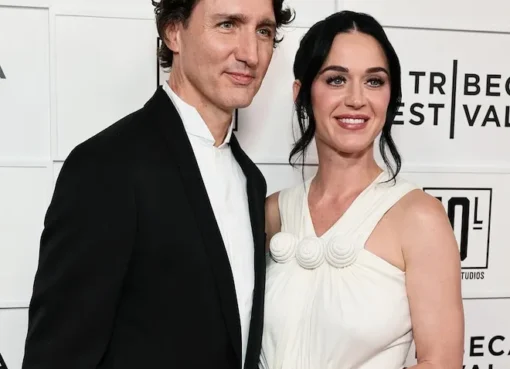 Katy Perry and Justin Trudeau smiling together on a red carpet