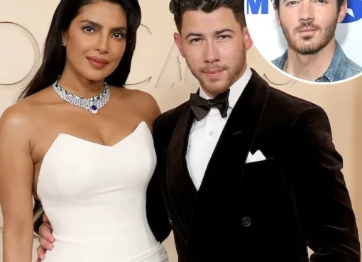 Kevin Jonas laughing with Nick Jonas and Priyanka Chopra at an event