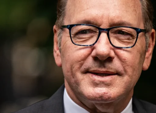 Kevin Spacey talking during a podcast interview with warm lighting