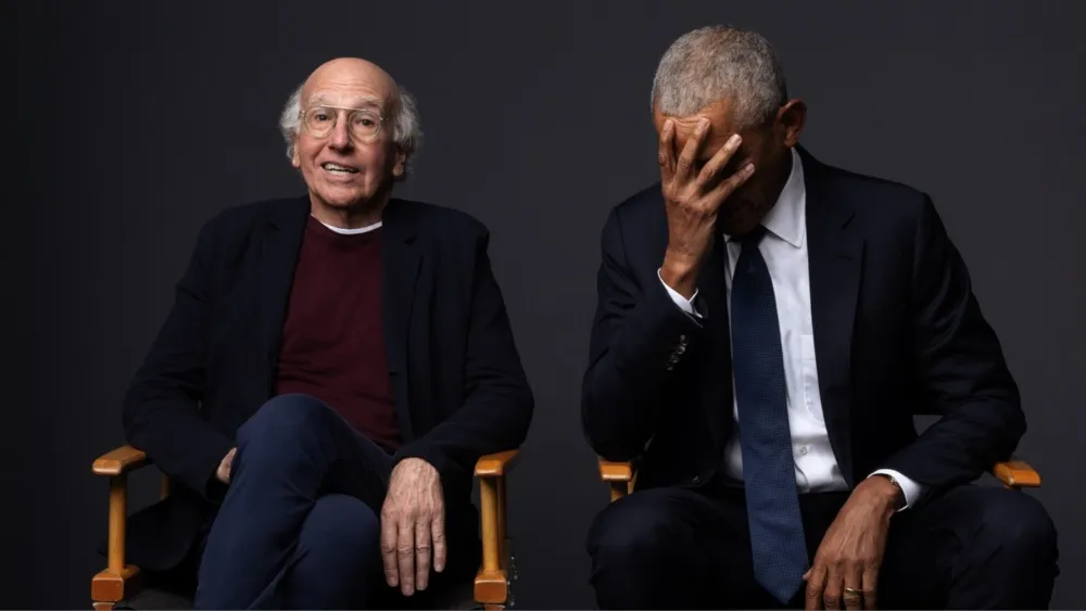 Larry David in historical costume on a TV show set.