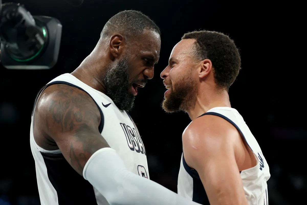 LeBron James and Stephen Curry smiling together during a basketball game