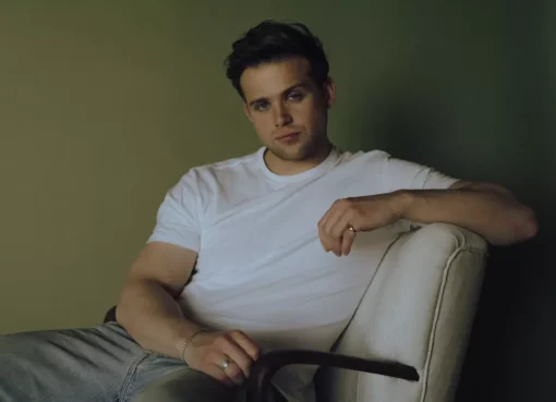 Leo Woodall posing for a portrait with a clean, sharp look
