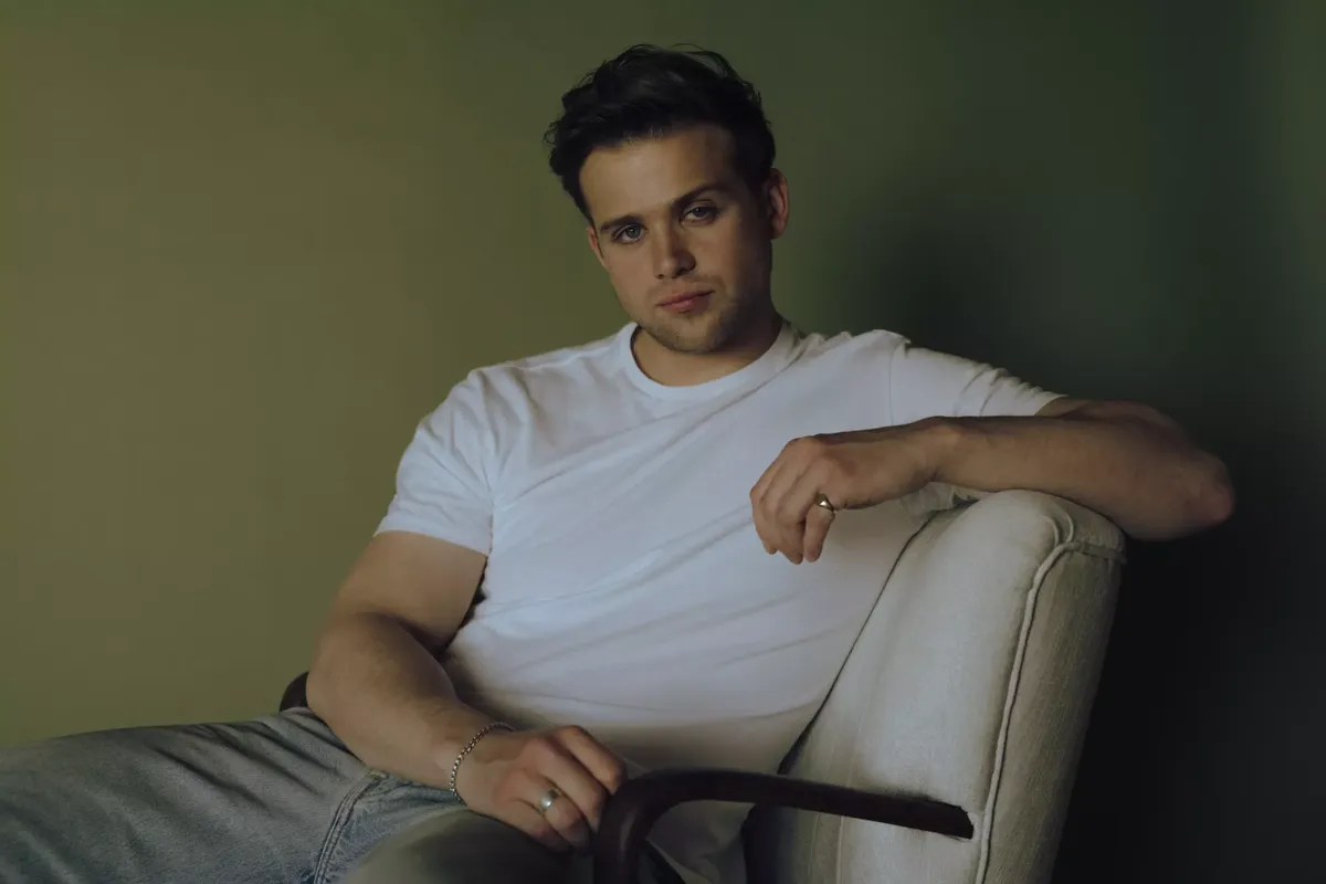 Leo Woodall posing for a portrait with a clean, sharp look