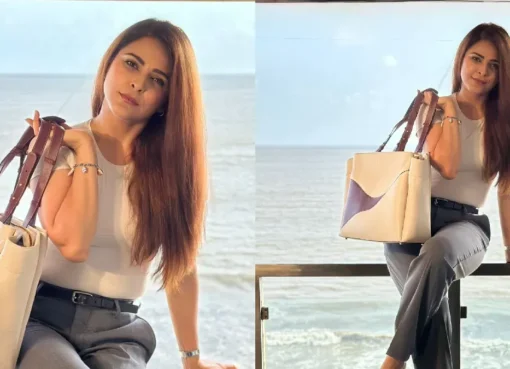 Madhurima Tuli posing in a chic semi-formal outfit with a stylish designer purse