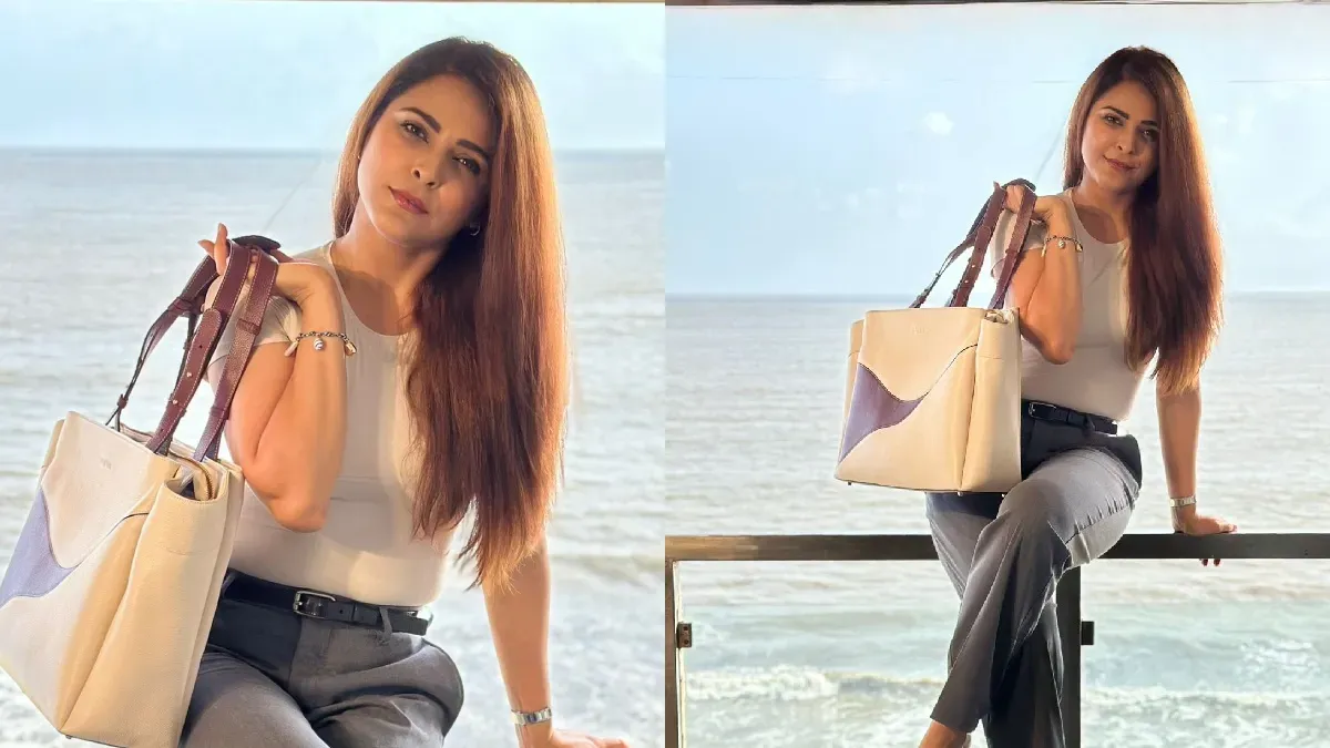 Madhurima Tuli posing in a chic semi-formal outfit with a stylish designer purse