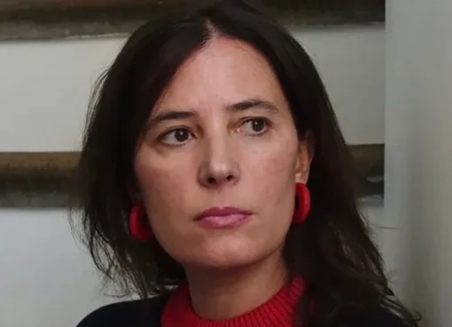 Milagros Mumenthaler smiling while speaking at a forum.