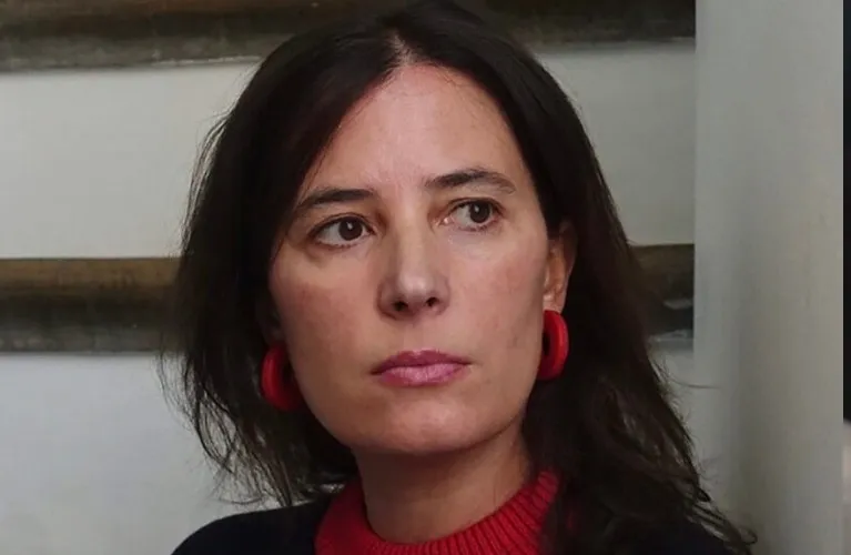 Milagros Mumenthaler smiling while speaking at a forum.
