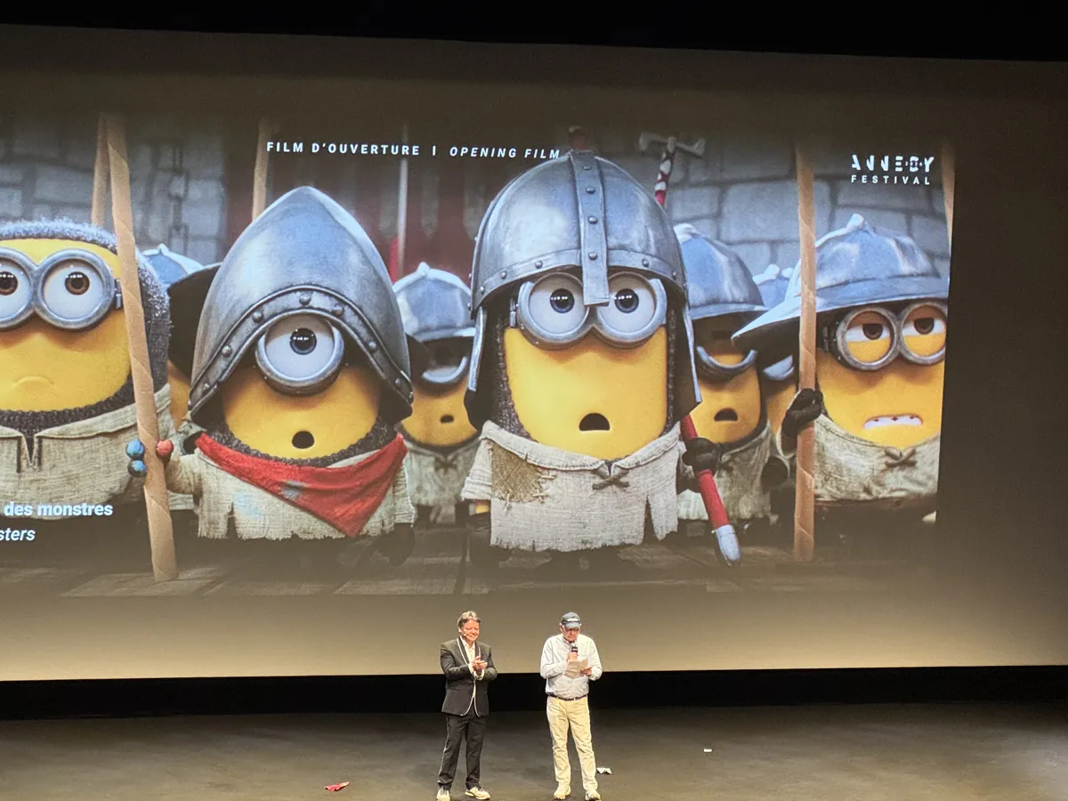 Animated Minions characters on a movie screen.