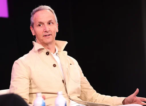 Tom Quinn speaking at a stage event about movies and YouTube