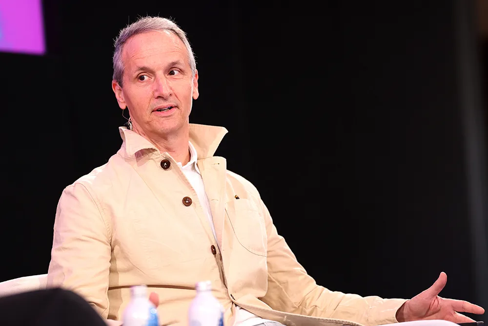Tom Quinn speaking at a stage event about movies and YouTube