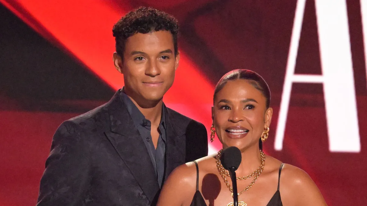 Nia Long and Jaafar Jackson on stage at the BET Awards, smiling and holding an award.
