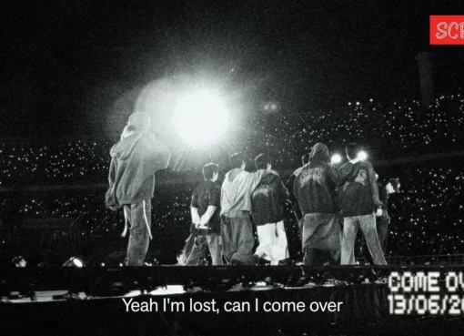 BTS members smiling and celebrating, with a soft, warm lighting aesthetic.