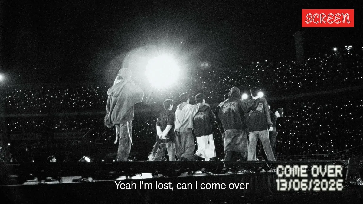 BTS members smiling and celebrating, with a soft, warm lighting aesthetic.