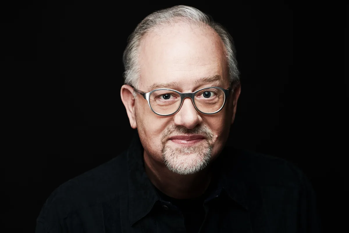 A headshot of playwright and screenwriter Doug Wright smiling slightly.
