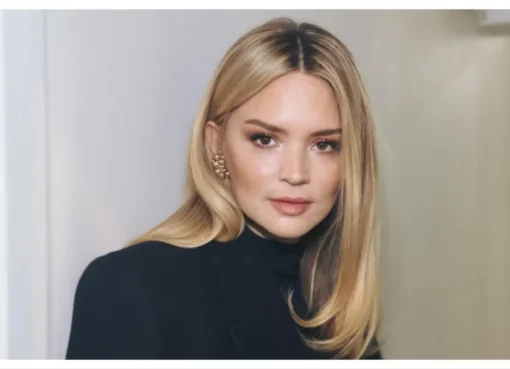 Virginie Efira smiling at a film festival, looking elegant and happy.