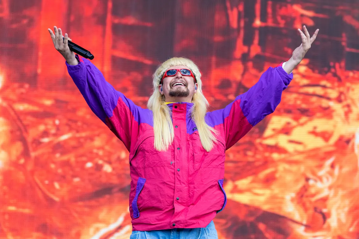 Oliver Tree in his signature bowl cut and oversized sunglasses, looking quirky and creative.