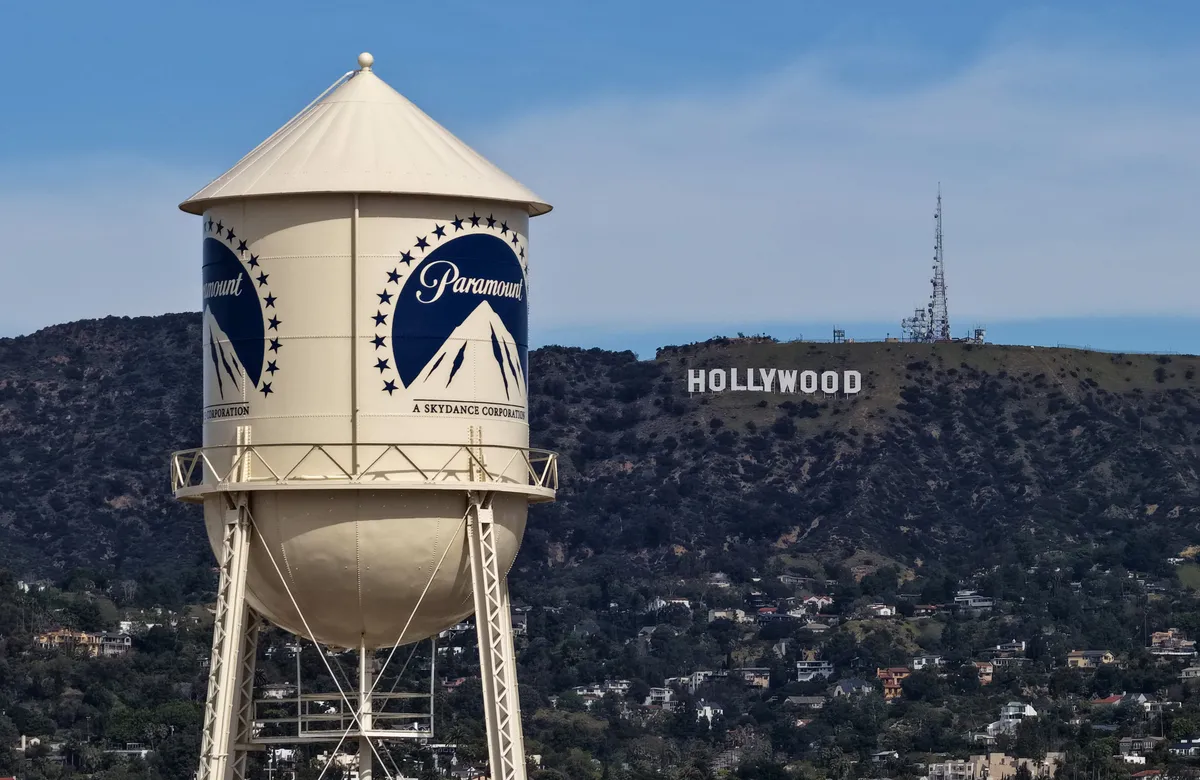 A graphic showing the logos of Paramount and Warner Bros. Discovery with a green checkmark.