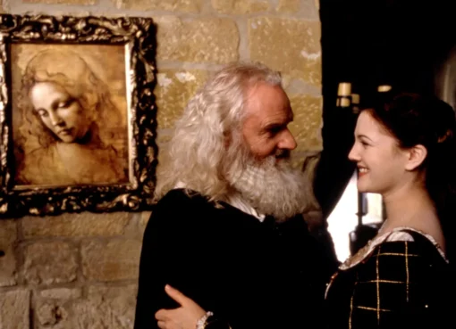A smiling Patrick Godfrey as Leonardo da Vinci from 'Ever After: A Cinderella Story', dressed in period attire.