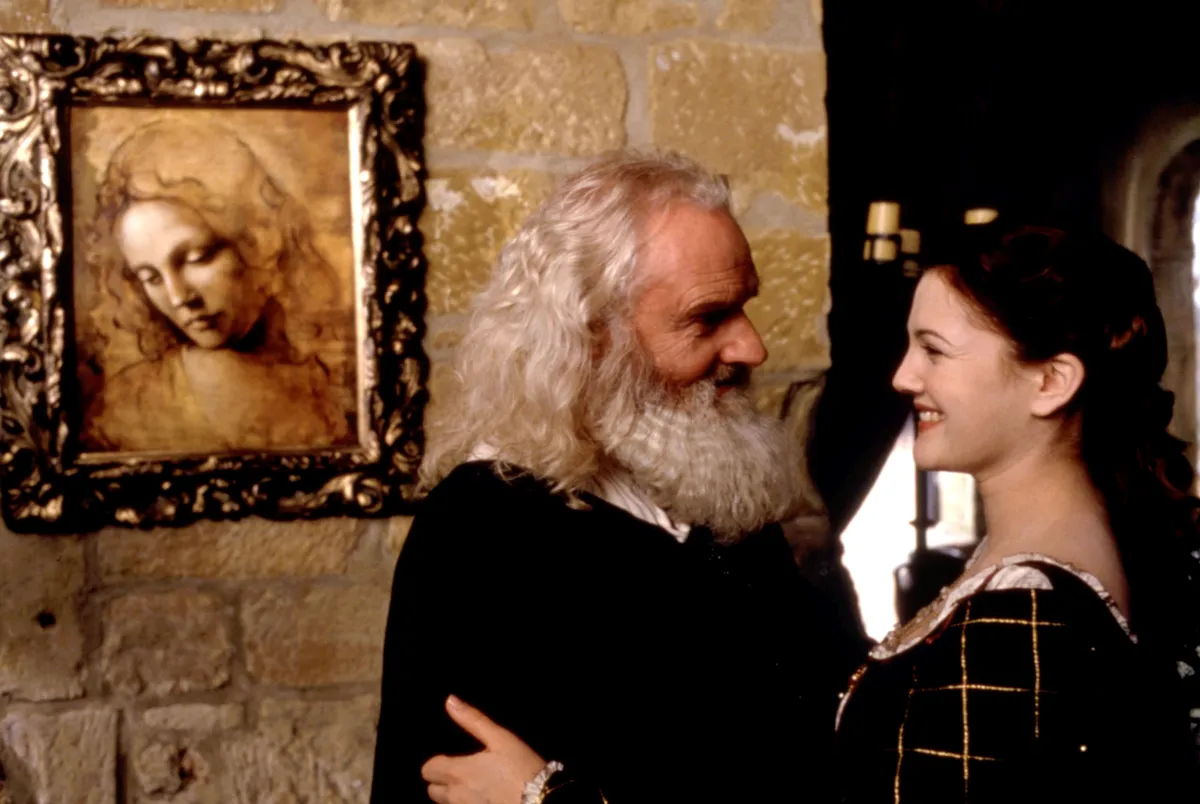A smiling Patrick Godfrey as Leonardo da Vinci from 'Ever After: A Cinderella Story', dressed in period attire.