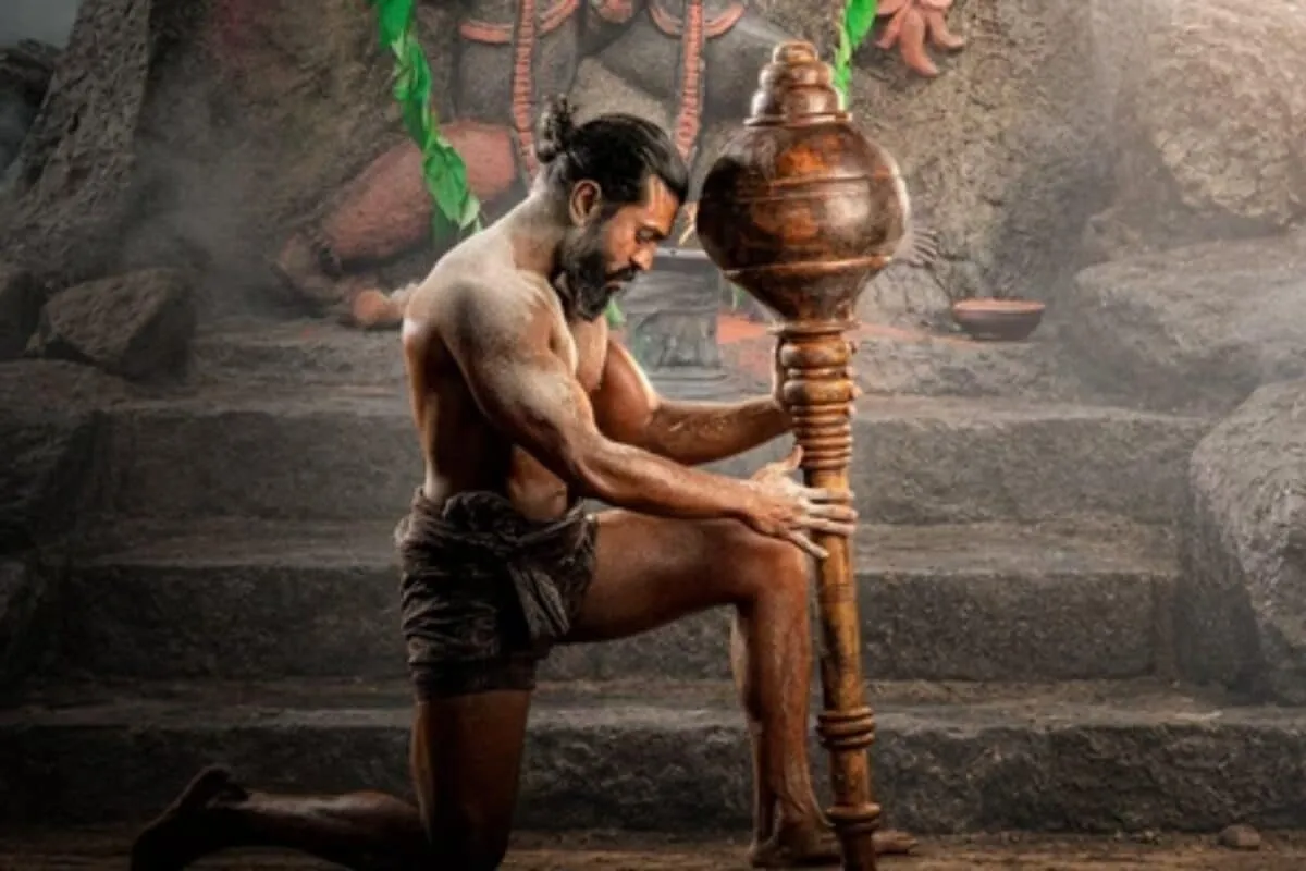 Movie poster with Ram Charan in action.