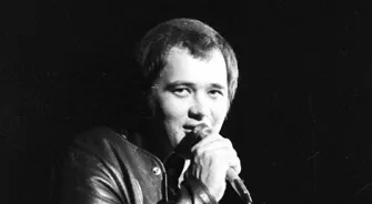 Close-up portrait of David Clayton-Thomas singing into a microphone.
