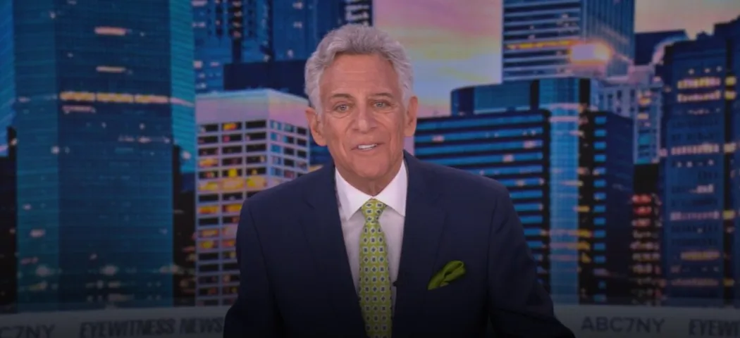 Photo of Bill Ritter smiling on a news set.