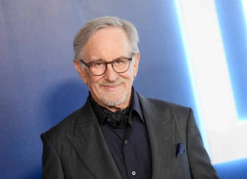 Steven Spielberg smiling and talking during a podcast appearance, likely sharing an anecdote.