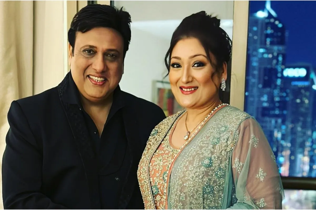 Sunita Ahuja smiling while speaking on a reality TV show set.