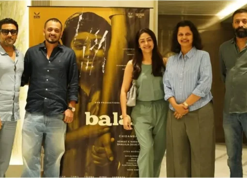 Actor Suriya smiling, looking appreciative, with text about 'Balan the Boy' on a phone screen.