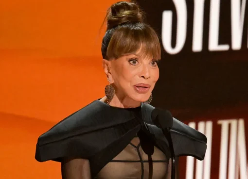Sylvia Rhone accepting an award with a powerful expression.