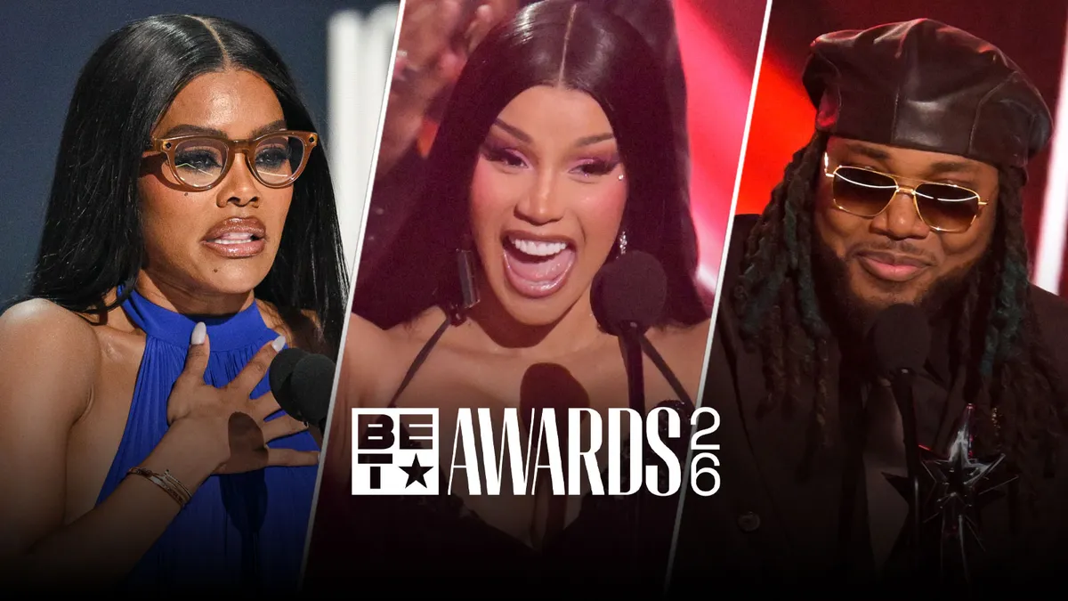 Teyana Taylor smiling while holding her BET Icon of the Year award